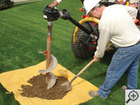 Auguring a hole in the earth for a foundation repair in Blackfoot