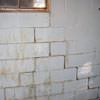 A cracked foundation wall near a window in a Kuna home