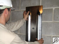 Mounting a foundation wall plate for an earth anchor installation in Rexburg.