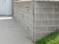 A retaining wall separating from the adjoining walls in 