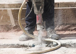 Jackhammering a slab floor in a Twin Falls home.