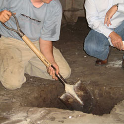 Digging a hole for the engineered fill used in a crawl space support system installation in Caldwell