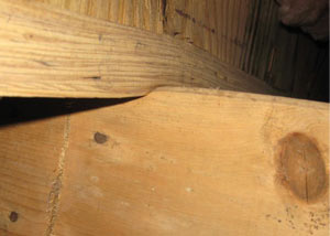 A failing girder showing signs of compression damage in a Idaho home