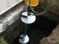 Installing a helical pier system in the earth around a foundation in Nampa