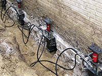 Using foundation push piers to lift a foundation during a repair in Post Falls.