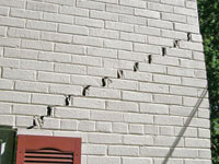 Stair-step cracks showing in a home foundation in Kuna