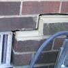 A closeup of a failed tuckpointing job where the brick cracked on a Preston home.