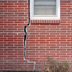 A foundation with a large crack that's wider at the top than on the bottom in Mountain Home