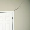 A long drywall crack beginning at the corner of a doorway in a Hayden home.