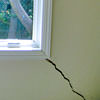 A long, diagonal crack that begins at a window corner of a Jerome home