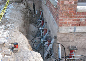 Foundation push piers installed around a house with a foundation settlement issues in Mountain Home