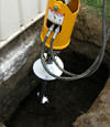 Installing a helical pier during a foundation repair in Nampa
