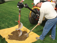 Auguring a hole in the earth for a foundation wall repair system in Lewiston