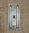 A fully exposed wall anchor plate installed along a  foundation wall
