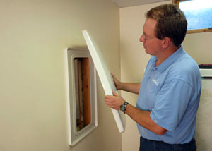 Foundation wall anchor covers installed in a finished basement with a repaired foundation wall in Mountain Home.