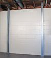 A steel i-beam system installed on a  foundation wall