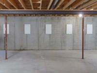 A repaired basement wall with foundation wall anchor covers installed in Twin Falls.