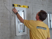 Positioning a wall plate cover on a foundation wall in Caldwell.