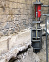 A completed installation of foundation push piers lifting a foundation in Burley