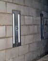 an inside view of foundation wall anchors installed along a basement wall to brace and repair the structure in Mountain Home