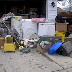 Soaked, wet personal items sitting in a driveway, including a washer and dryer in Caldwell.