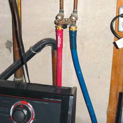 Washer hoses in a basement  in Preston