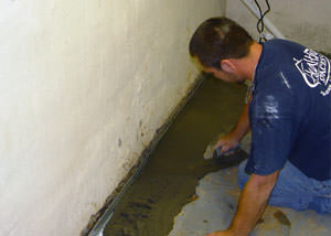 Restoring a concrete slab floor with fresh concrete after jackhammering it and installing a drain system in Rathdrum.