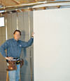 Installing wall panels on top of our basement wall insulation in Caldwell