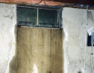Water pouring out from a basement window in Meridian